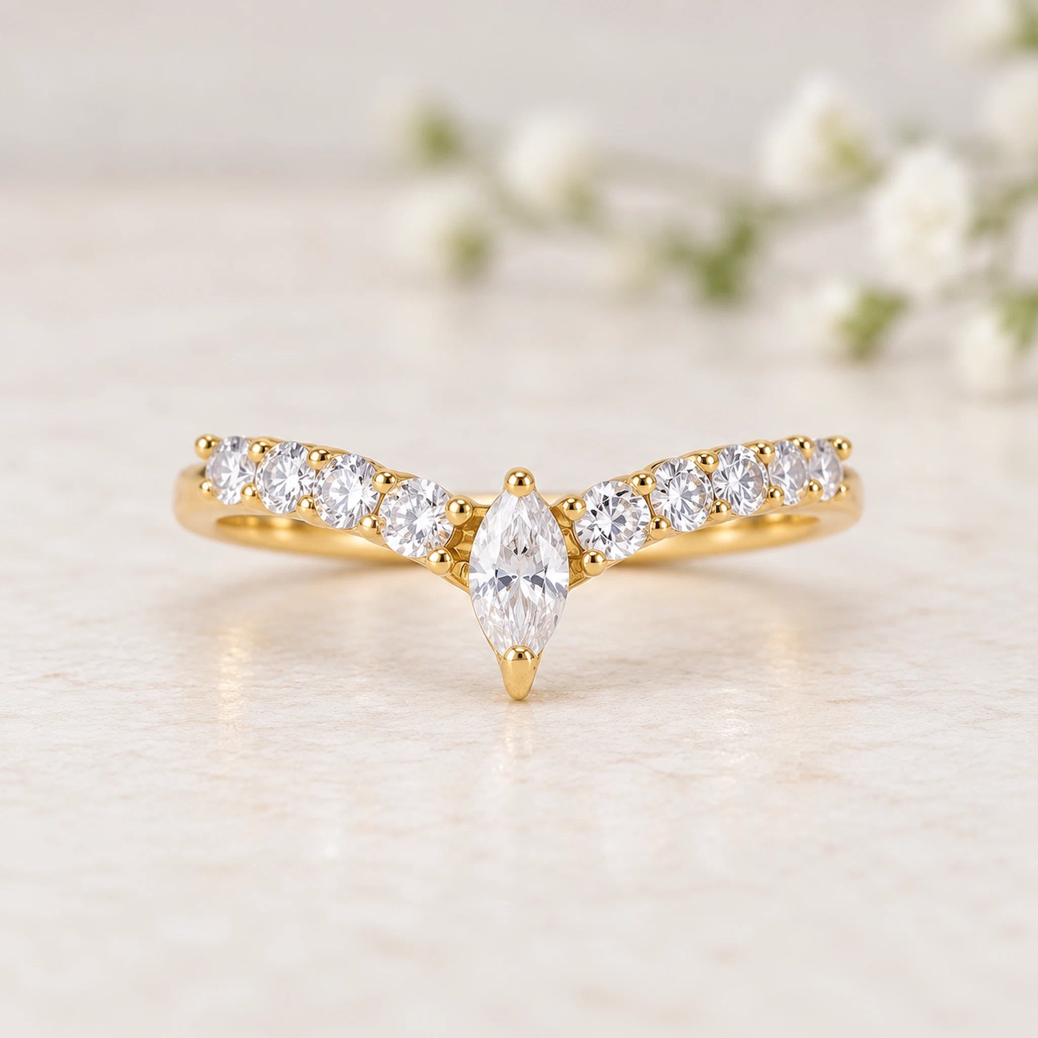gold vermeil chevron ring with cubic zirconias on a light background