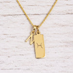 gold initial N pendant and pisces zodiac star sign pendant on a fine gold chain
