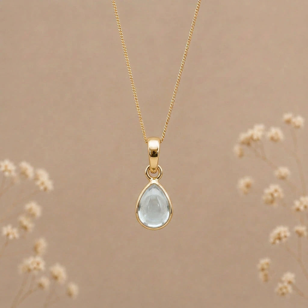 Gold November birthstone blue topaz necklace with a pear-shaped pendant
