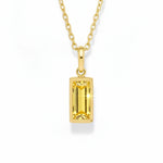 gold november birthstone necklace with yellow cubic zirconia on a white background.