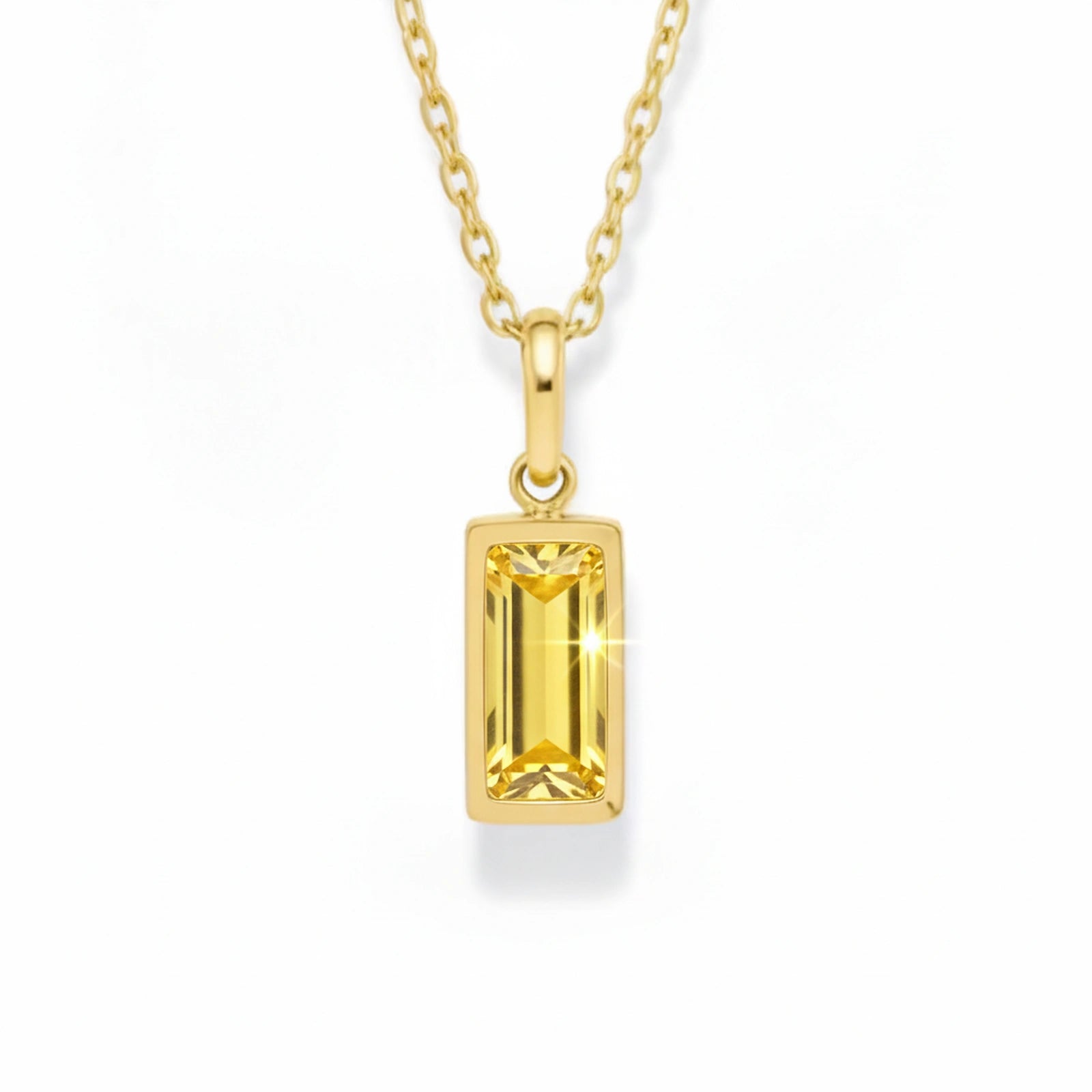gold november necklace with yellow cubic zirconia on a white background.