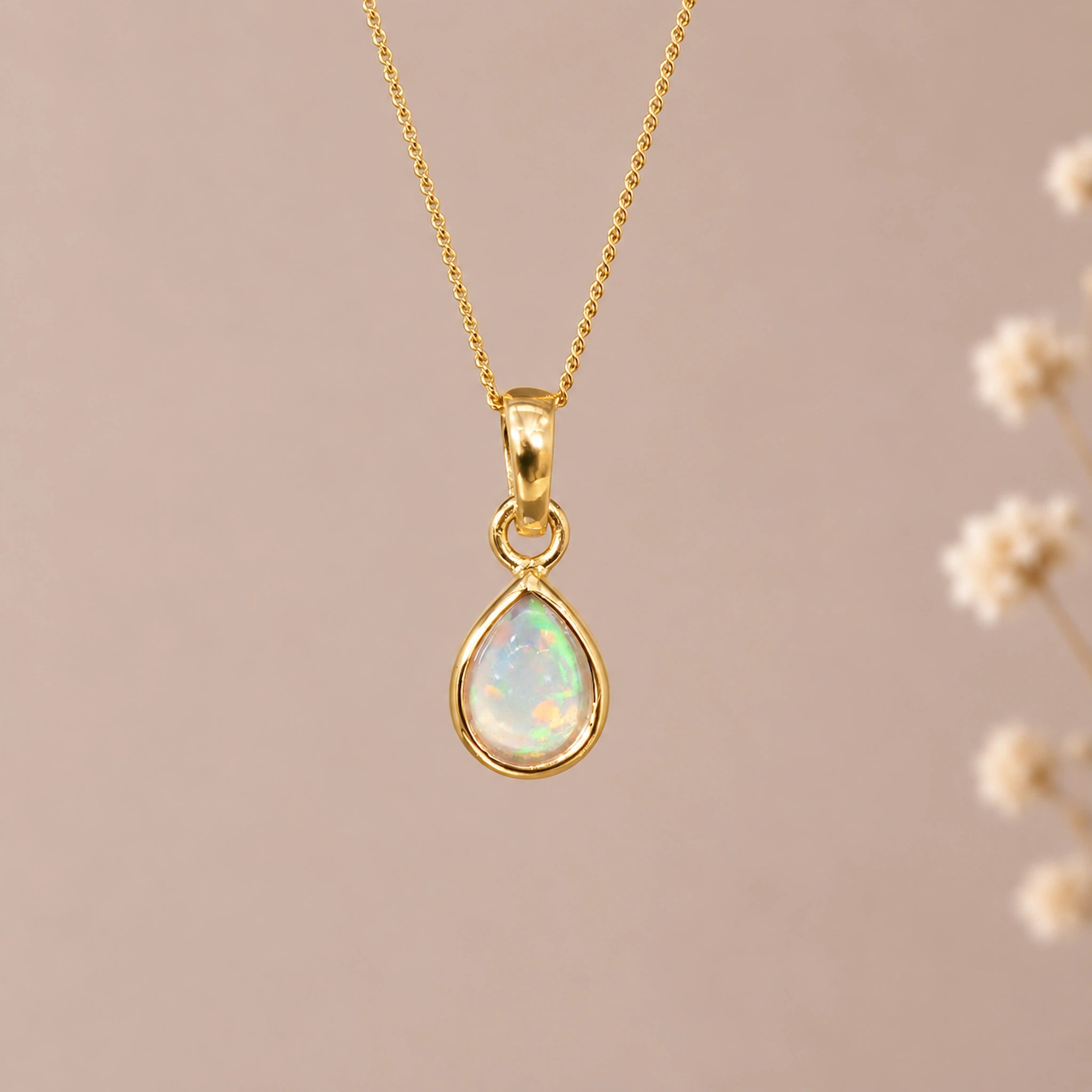 gold october birthstone necklace with a teardrop bezel-set cabochon natural opal stone pendant hanging