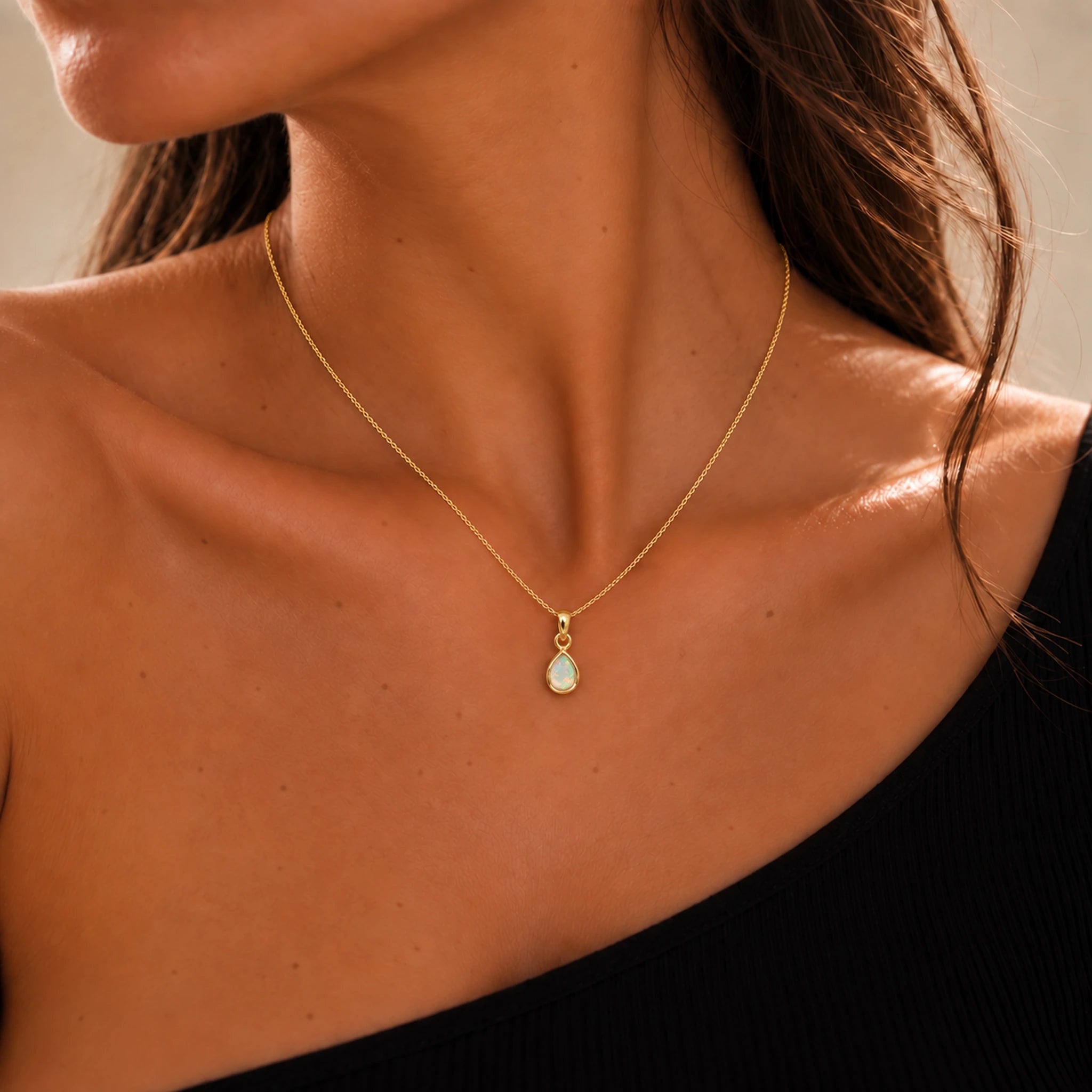 Model wearing a gold October birthstone opal necklace