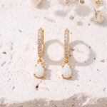 Gold opal teardrop huggie earrings close-up front view, pavé CZ hoops and teardrop opal drops