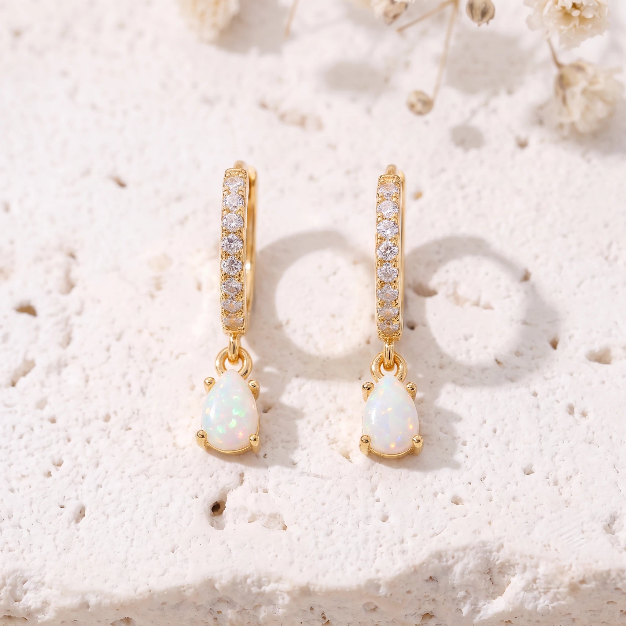 Gold opal teardrop huggie earrings close-up front view, pavé CZ hoops and teardrop opal drops