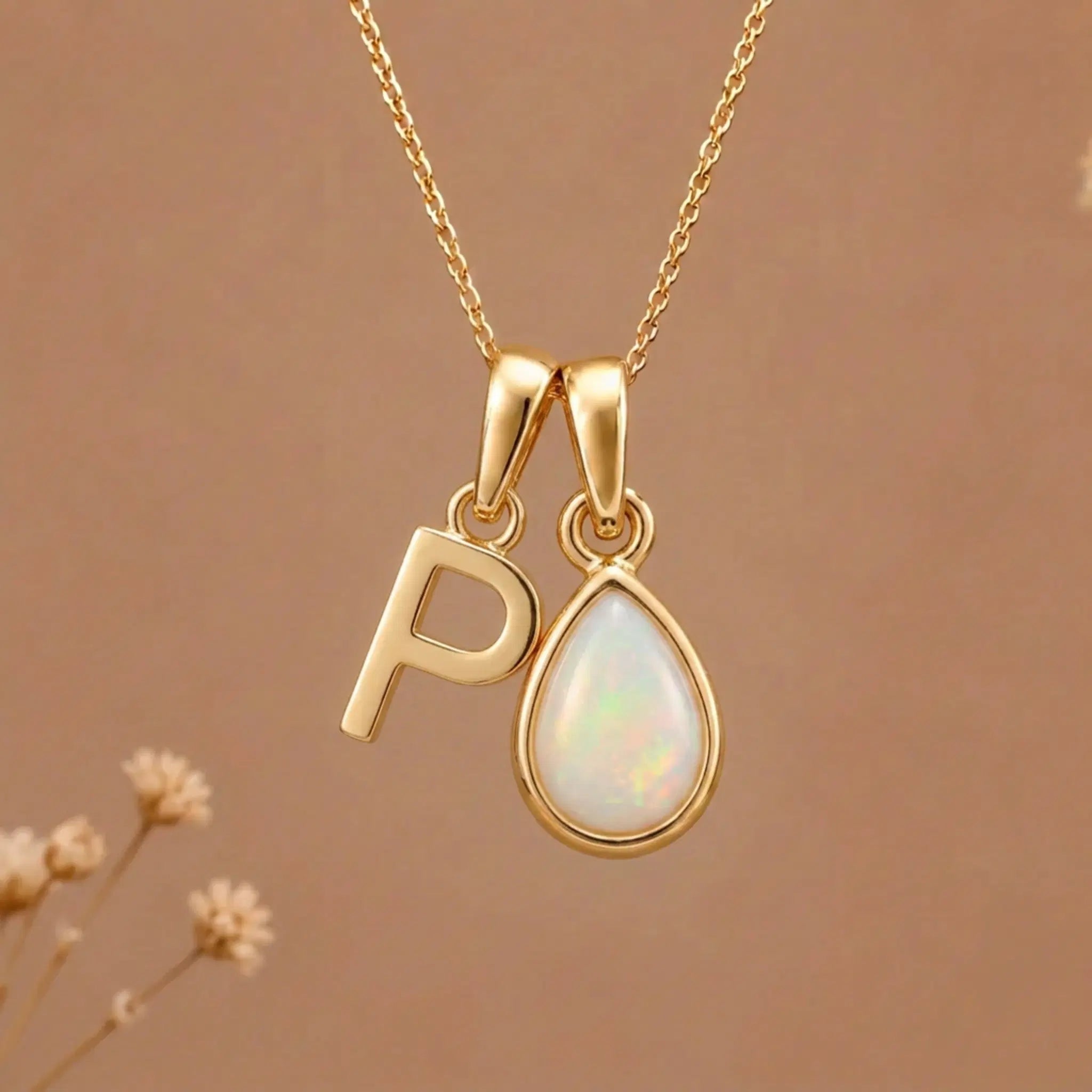 Gold Initial P Pendant and October birthstone Natural Opal Necklace against a warm background