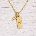 gold initial P pendant and pisces zodiac star sign pendant on a fine gold chain