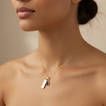 Gold February Birthstone Necklace with a pear-shaped natural Amethyst gemstone pendant and Pisces Zodiac pendant worn