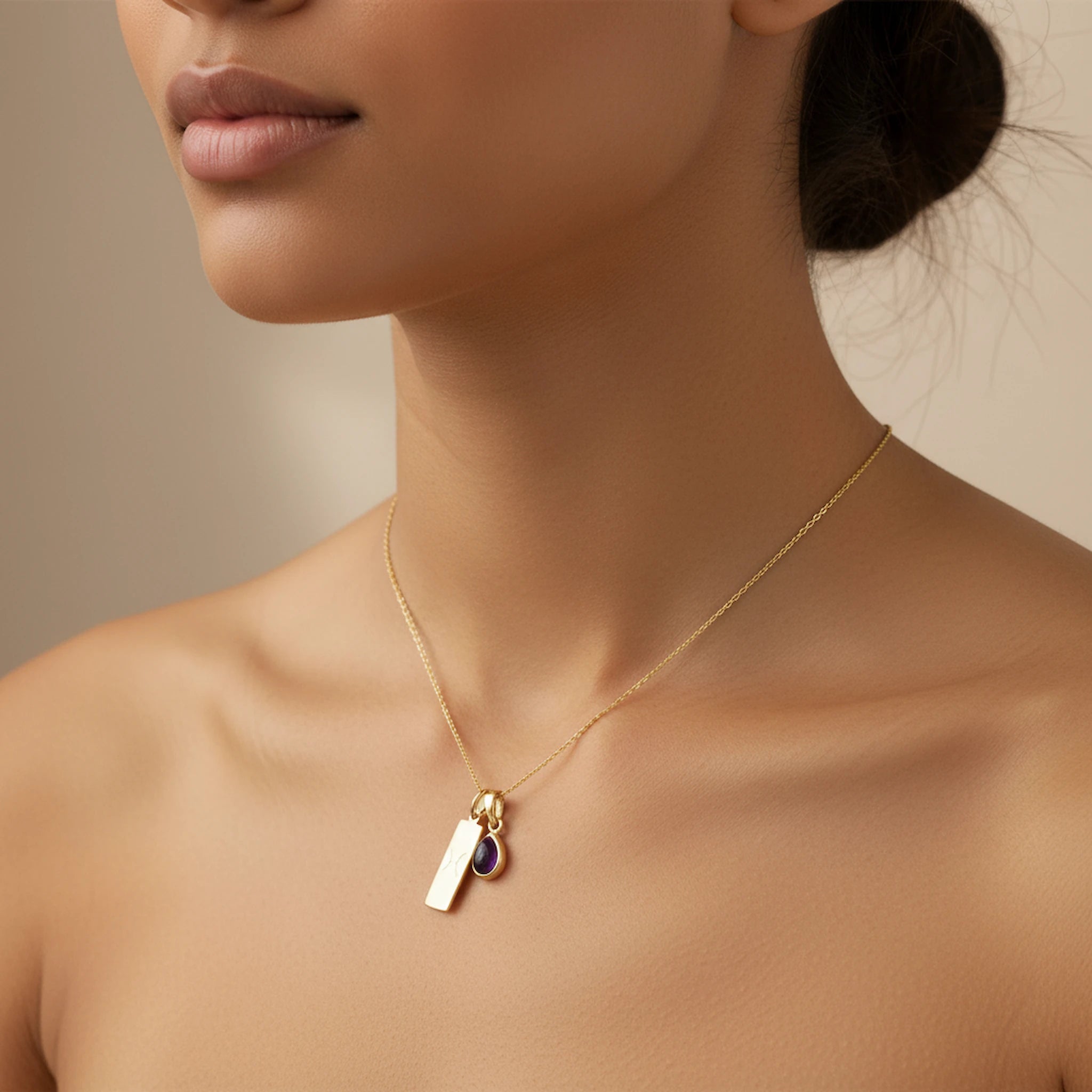 Gold February Birthstone Necklace with a pear-shaped natural Amethyst gemstone pendant and Pisces Zodiac pendant worn