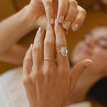 Close-up of a hand with rings on a blurred background