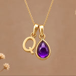 Gold initial Q necklace with a natural February amethyst