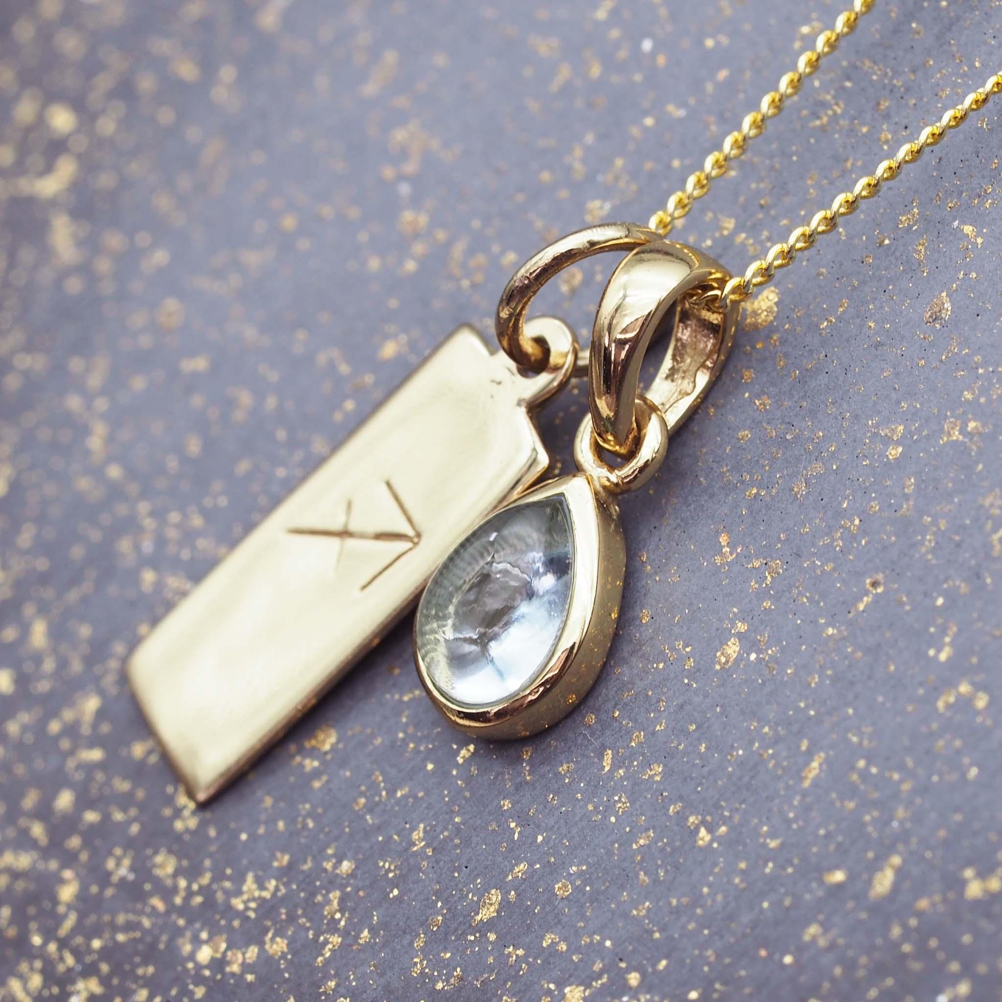 gold necklace with a Sagittarius Zodiac pendant and November Birthstone blue topaz pendant