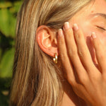 Woman wearing gold hoop Earrings -waterproof jewellery indie and Harper