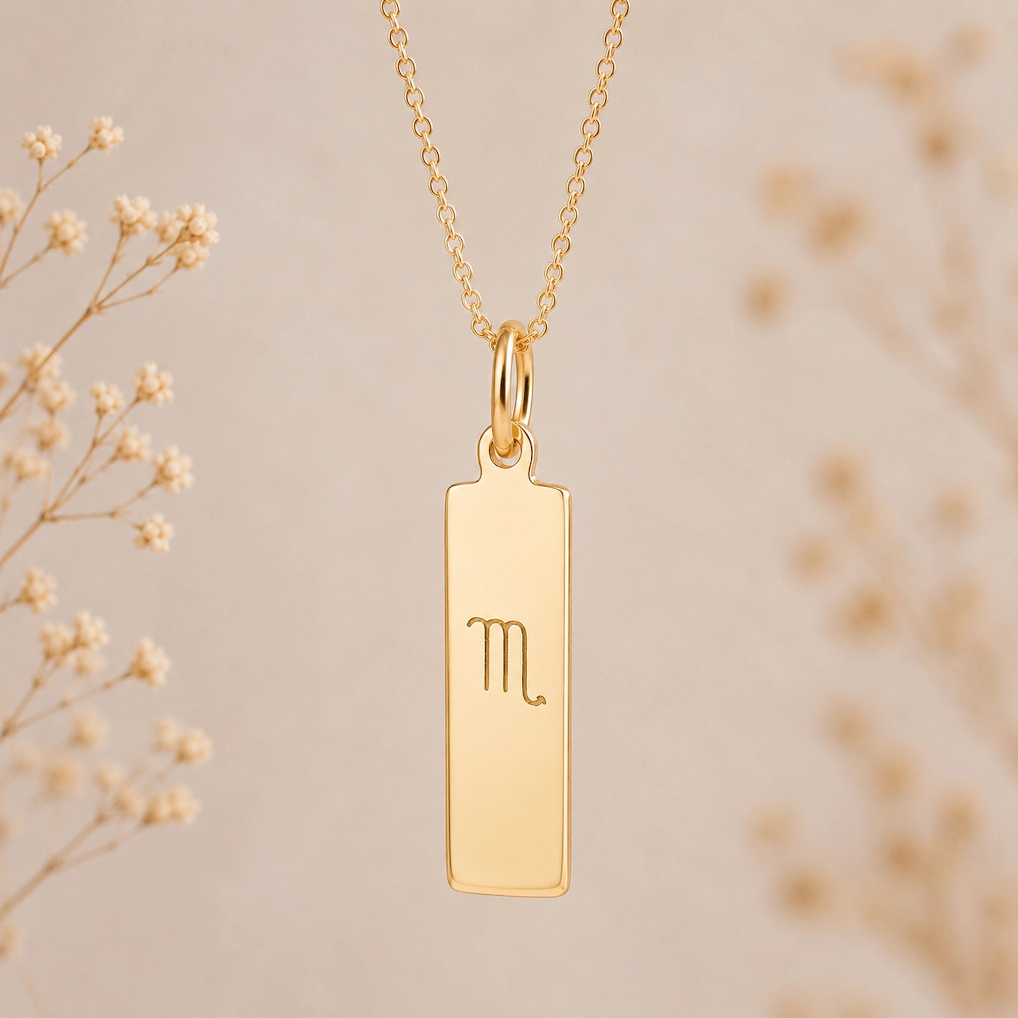 gold scorpio necklace with rectangle pendant featuring engraved minimalist scorpio zodiac star sign line glyph symbol suspended from a fine chain