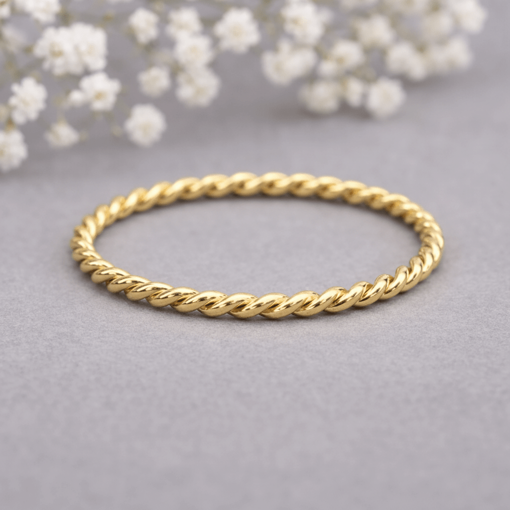 gold stacker ring on a light grey surface