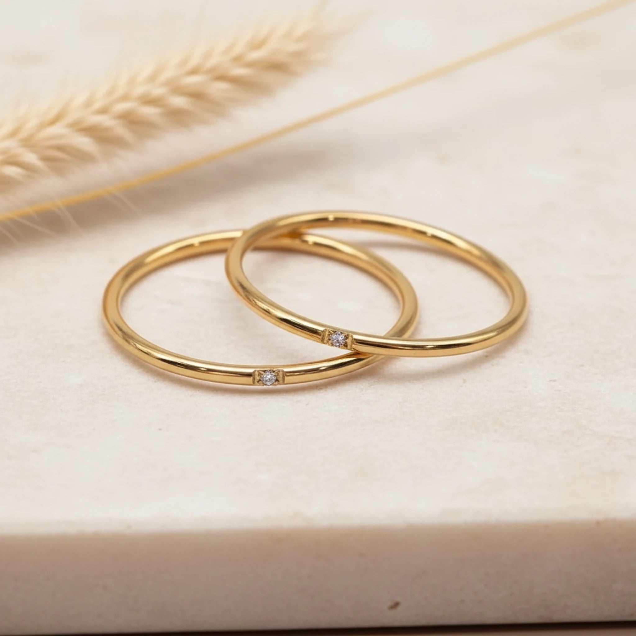 two minimalist waterproof gold stacker rings with dainty cubic zirconias