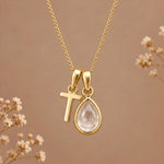 Gold initial T necklace with an April clear quartz teardrop on brown with dried flowers