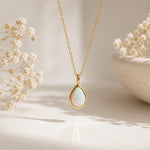 gold teardrop white opal pendant necklace hanging