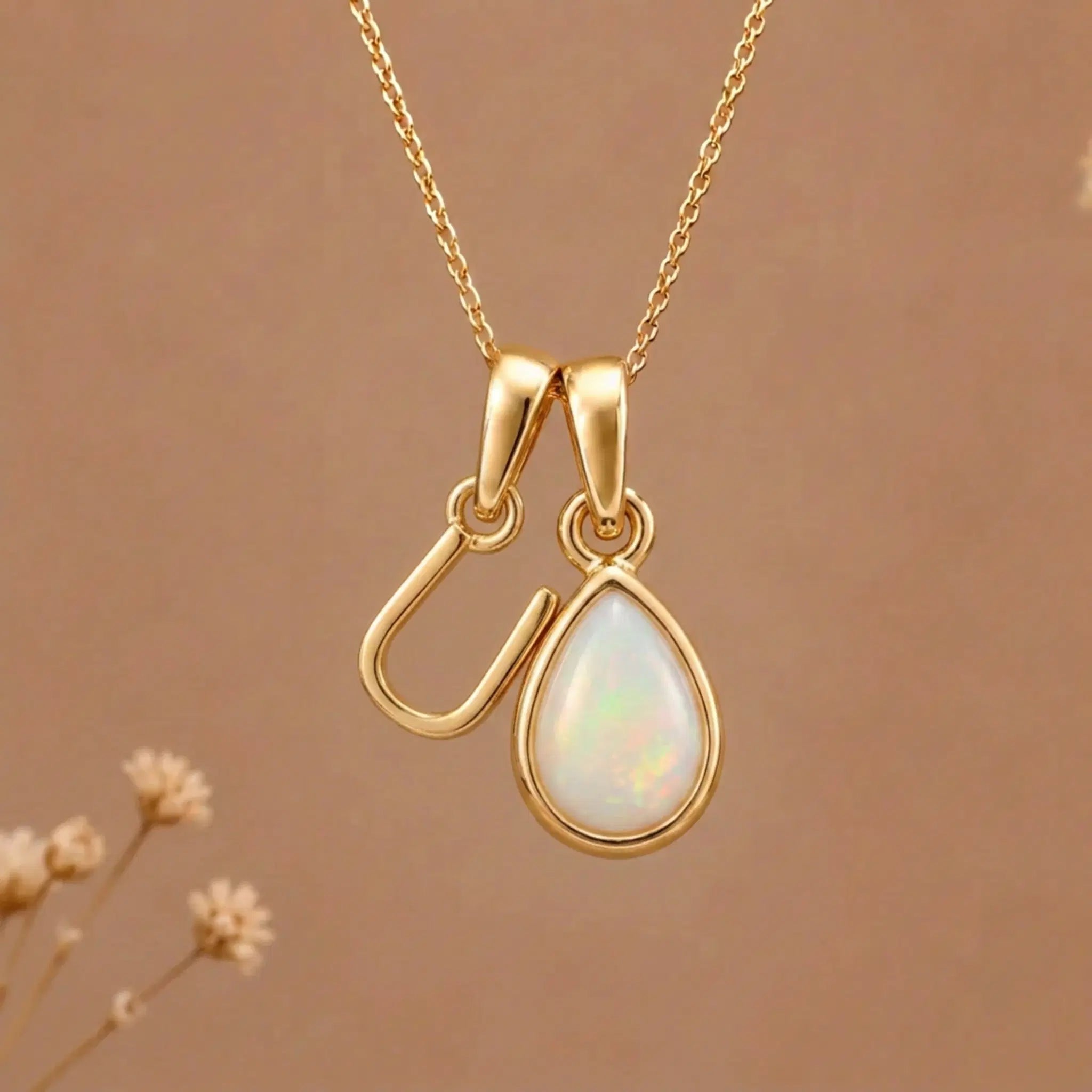 Gold Initial U Pendant and October birthstone Natural Opal Necklace against a warm background
