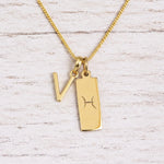 gold initial V pendant and pisces zodiac star sign pendant on a fine gold chain
