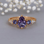 Gold vermeil ring with purple alexandrite gemstones on a gray background