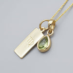 Gold necklace with a virgo zodiac pendant and a green natural peridot gemstone teardrop pendant 
