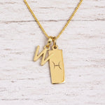 gold initial W pendant and pisces zodiac star sign pendant on a fine gold chain