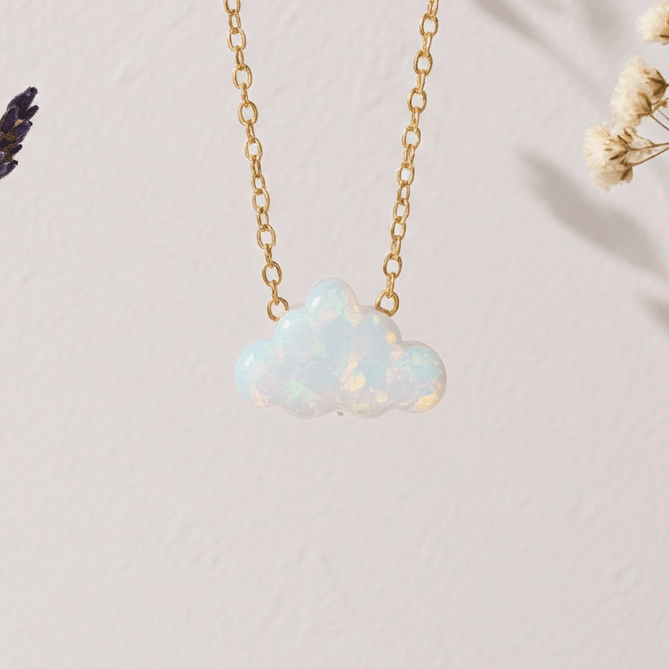 cloud shaped Opal necklace on a gold chain with lavender and dried flowers on a light background