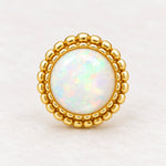 Gold white opal stud earring close-up