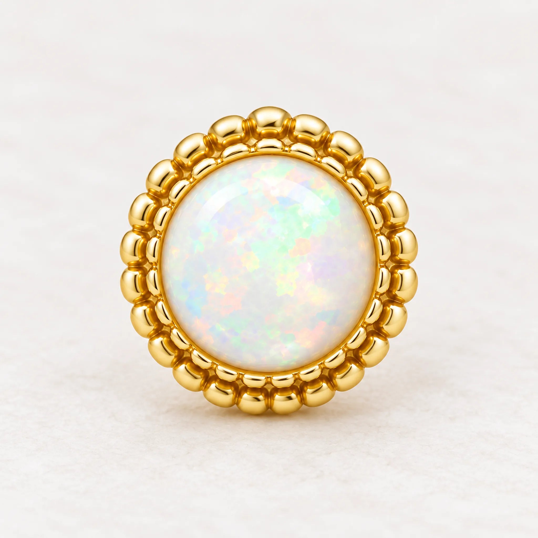 Gold white opal stud earring close-up