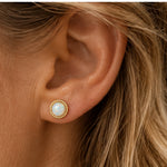 Gold white opal stud earring worn on ear, approximately 6 mm