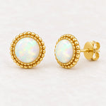 Gold white opal stud earrings, angled view