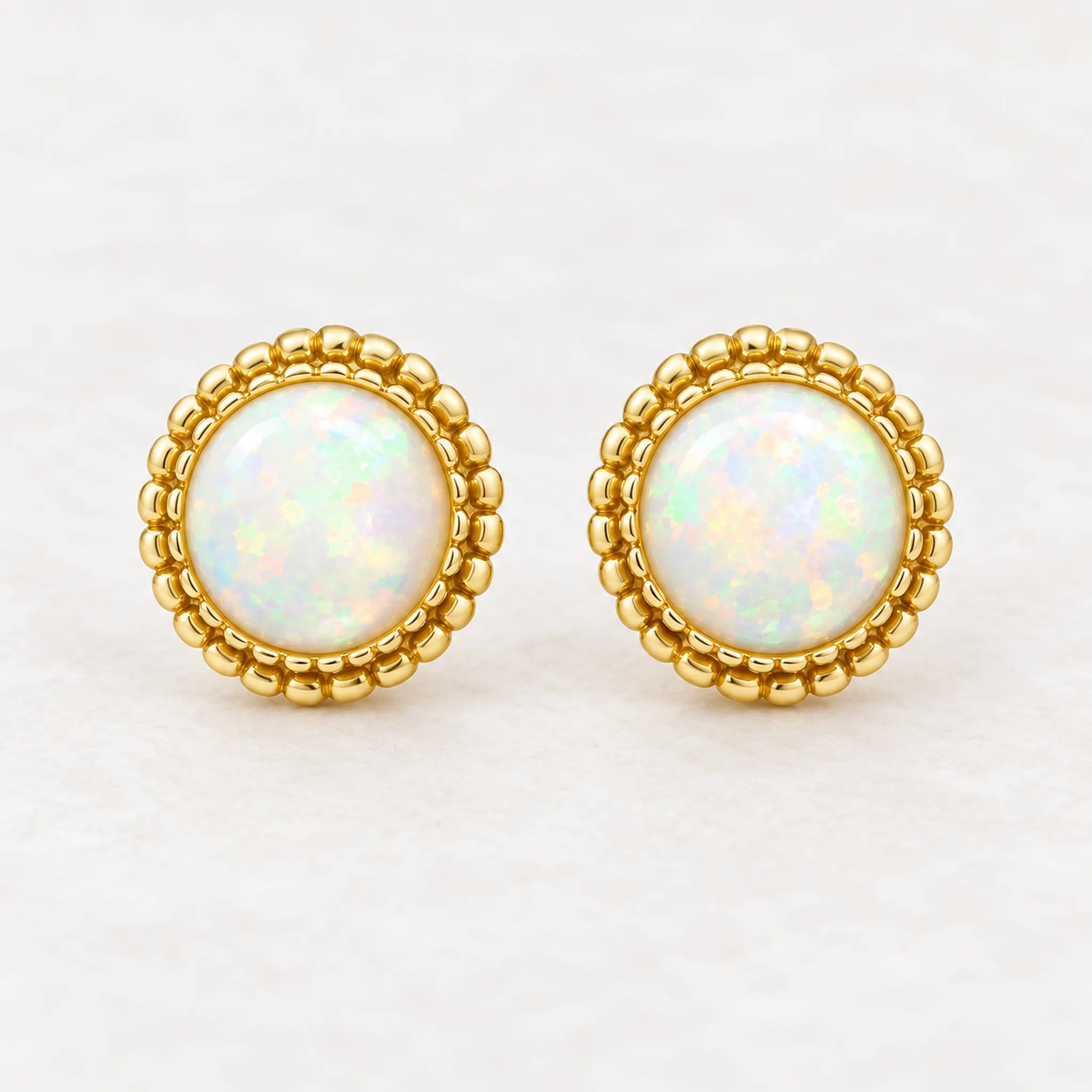 Gold white opal stud earrings, front view