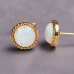Gold White Opal stud earrings on a grey background