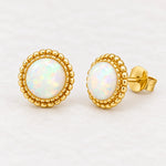 Gold white opal stud earrings, pair angled view