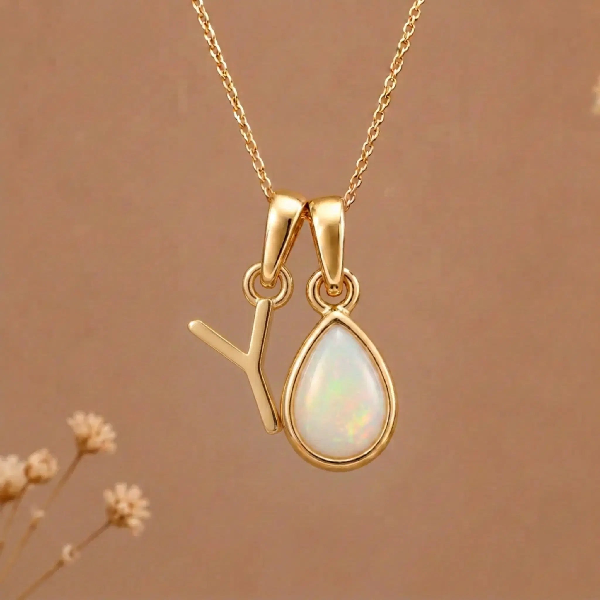 Gold Initial Y Pendant and October birthstone Natural Opal Necklace against a warm background