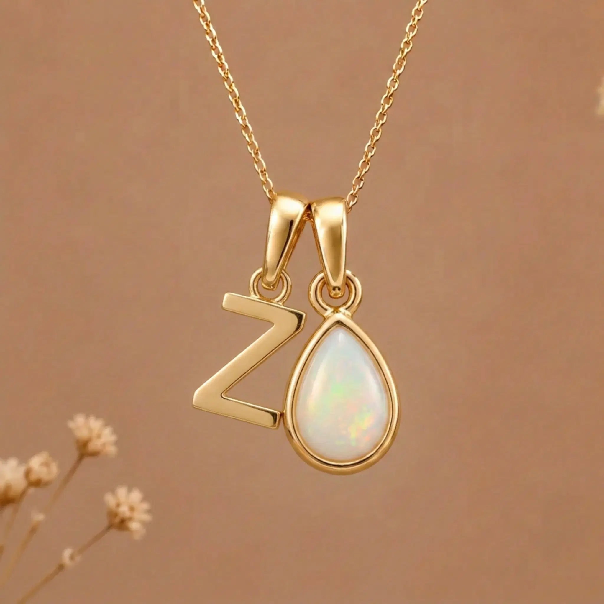 Gold Initial Z Pendant and October birthstone Natural Opal Necklace against a warm background