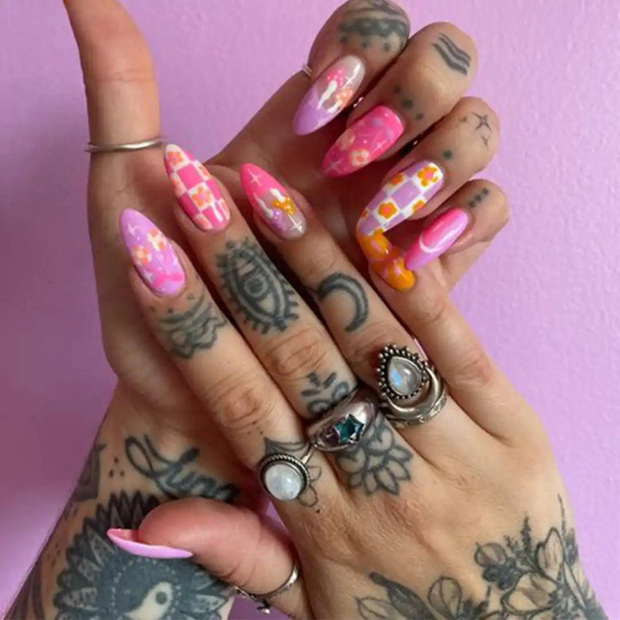Hand with pink nails and tattoos wearing boho rings - moonstone jewellery Australia 