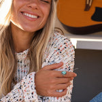 Smiling woman wearing a sterling silver Navajo turquoise ring