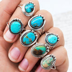 Hand wearing sterling silver Navajo turquoise rings