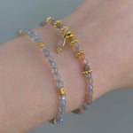 indie and harper dainty goddess orange moonstone bracelet being worn