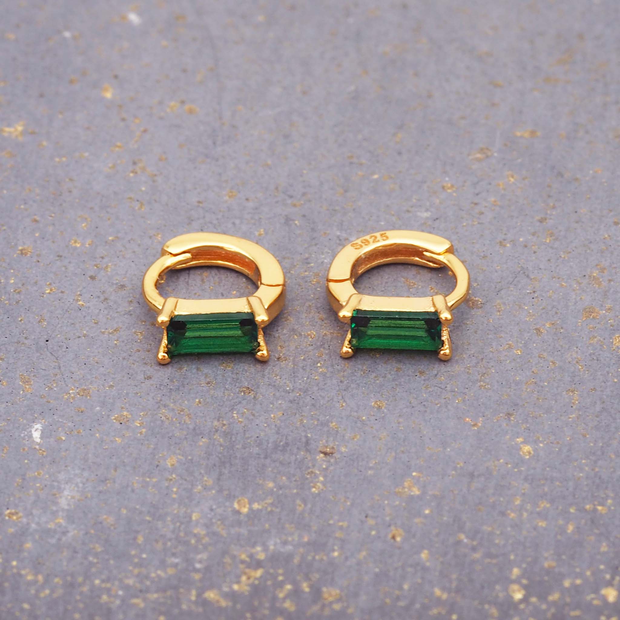 indie and harper dainty gold and emerald green huggie earrings 