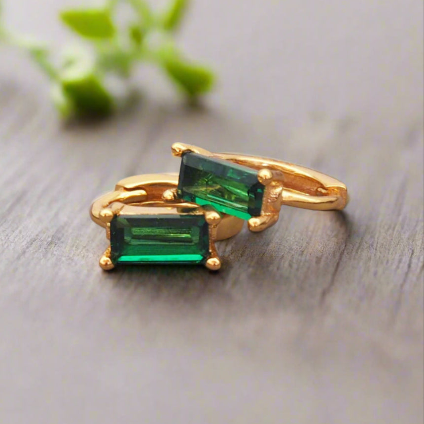 dainty gold huggie earrings with emerald green cubic zirconia by indie and harper australia