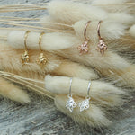 Gold, rose gold and silver earrings on dried flowers with a neutral background - indie and harper jewellery australia