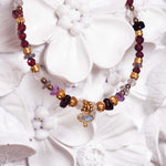 indie and harper bracelet with natural gemstones on a white floral background