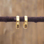 indie and harper dainty gold huggie earrings with dainty star and cubic zirconia detail
