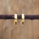 indie and harper dainty gold huggie earrings with dainty star and cubic zirconia detail