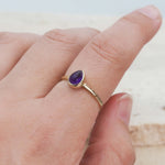 indie and harper gold february birthstone amethyst ring being worn
