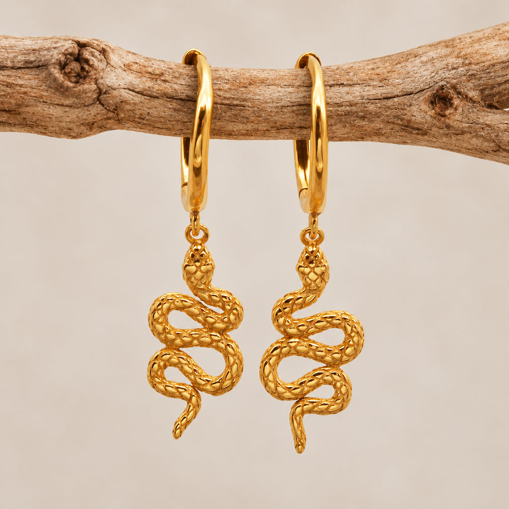 Gold serpent huggie hoop earrings with a snake charm