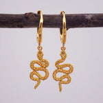 indie and harper gold huggie style earrings with serpent charm